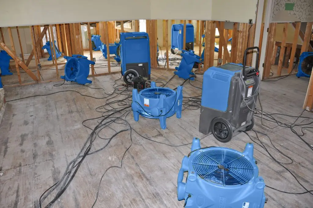 Air movers drying a gutted Fort Worth room after major water damage